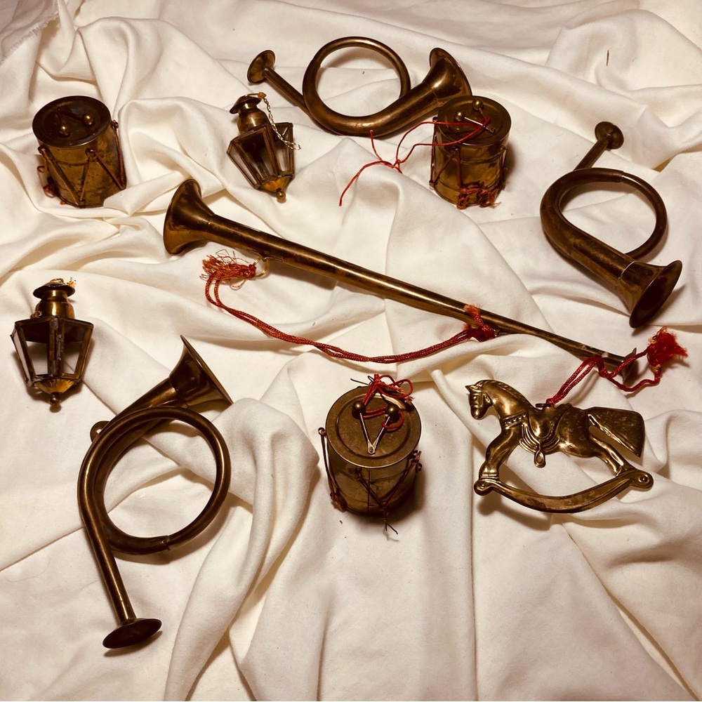 Vintage collection of holiday brass musical decorations hanging & on gifts
